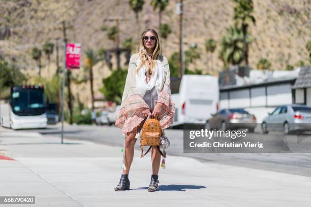 Nina Suess wearing Chloe top, boots and sunglasses, MCM backpack during day 1 of the 2017 Coachella Valley Music & Arts Festival Weekend 1 on April...