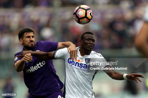 Nenad Tomovic of ACF Fiorentina battles for the ball with Mame Baba Thiam of Empoli FC during the Serie A match between ACF Fiorentina and Empoli FC...