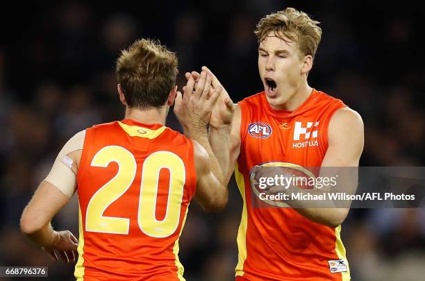 Michael Barlow and Tom Lynch of the Suns celebrate during the 2017 AFL round 04 match between the Carlton Blues and the Gold Coast Suns at Etihad...