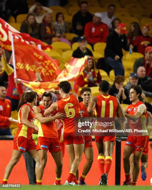 The Suns celebrate during the 2017 AFL round 04 match between the Carlton Blues and the Gold Coast Suns at Etihad Stadium on April 15, 2017 in...