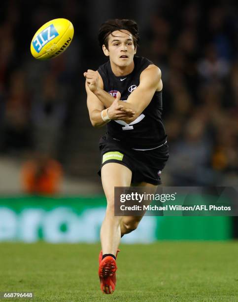 Debutant, Zac Fisher of the Blues handpasses the ball during the 2017 AFL round 04 match between the Carlton Blues and the Gold Coast Suns at Etihad...