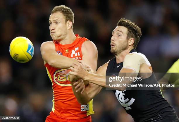 Brandon Matera of the Suns and Dale Thomas of the Blues compete for the ball during the 2017 AFL round 04 match between the Carlton Blues and the...