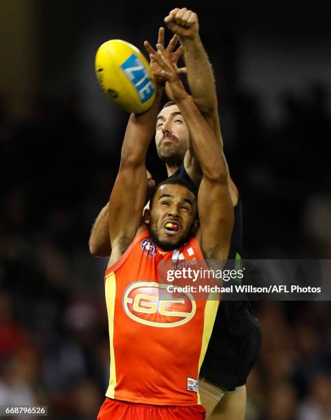 Touk Miller of the Suns and Kade Simpson of the Blues compete for the ball during the 2017 AFL round 04 match between the Carlton Blues and the Gold...