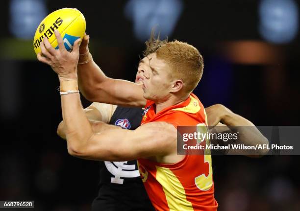 Peter Wright of the Suns and Tom Williamson of the Blues compete for the ball during the 2017 AFL round 04 match between the Carlton Blues and the...