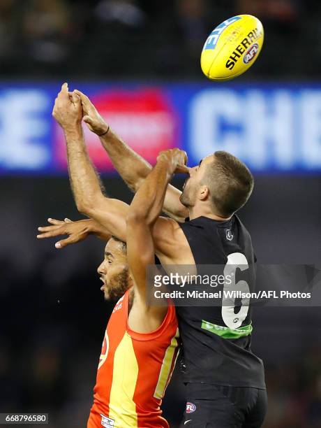 Touk Miller of the Suns and Kade Simpson of the Blues compete for the ball during the 2017 AFL round 04 match between the Carlton Blues and the Gold...