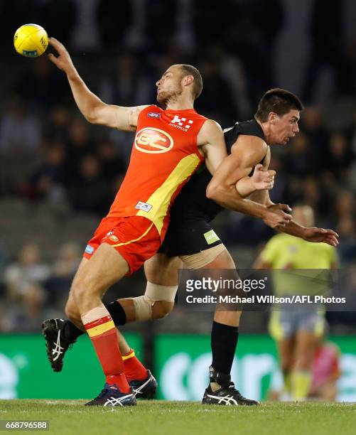 Jarrod Witts of the Suns and Matthew Kreuzer of the Blues compete in a ruck contest during the 2017 AFL round 04 match between the Carlton Blues and...