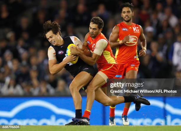 Jack Silvagni of the Blues and Jack Martin of the Suns compete for the ball during the 2017 AFL round 04 match between the Carlton Blues and the Gold...