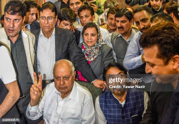 Former Chief Minister and National Conference patron Farooq Abdullah, flashes victory sign at his party headquarters after winning the elections of...