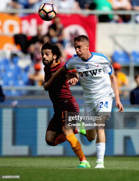 Andrea Conti of Atalanta BC competes for the ball with Mohamed Salah of AS Roma during the Serie A match between AS Roma and Atalanta BC at Stadio...