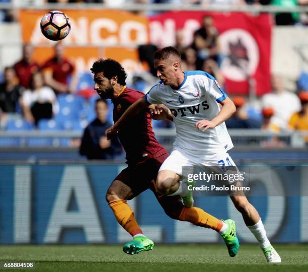 Andrea Conti of Atalanta BC competes for the ball with Mohamed Salah of AS Roma during the Serie A match between AS Roma and Atalanta BC at Stadio...