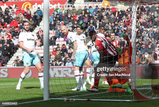 Victor Anichebe of Sunderland challenges Darren Randolph of West Ham United as Wahbi Khazri of Sunderland scores his sides first goal during the...