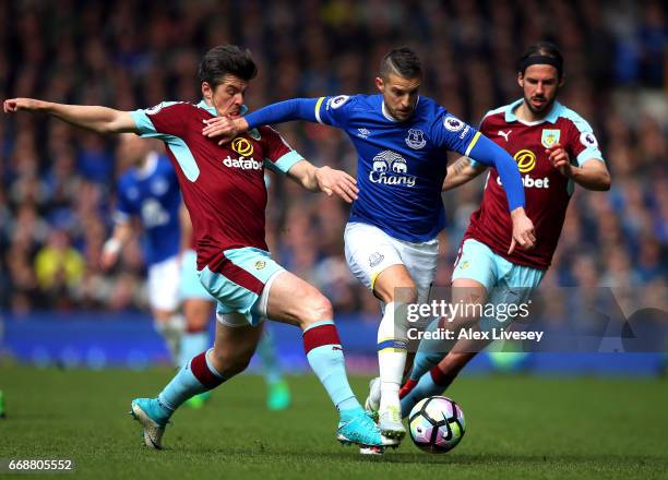 Joey Barton of Burnley tackles Kevin Mirallas of Everton during the Premier League match between Everton and Burnley at Goodison Park on April 15,...