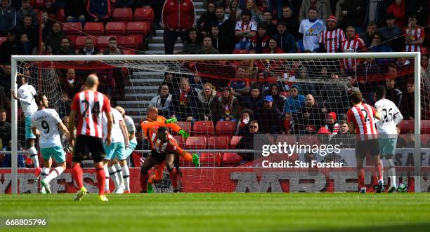 Victor Anichebe of Sunderland challenges Darren Randolph of West Ham United as Wahbi Khazri of Sunderland scores his sides first goal during the...