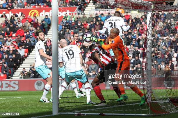 Victor Anichebe of Sunderland challenges Darren Randolph of West Ham United as Wahbi Khazri of Sunderland scores his sides first goal during the...