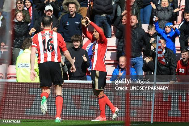 Sunderland's French-born Tunisian midfielder Wahbi Khazri celebrates his opening goal with Sunderland's Irish defender John O'Shea during the English...