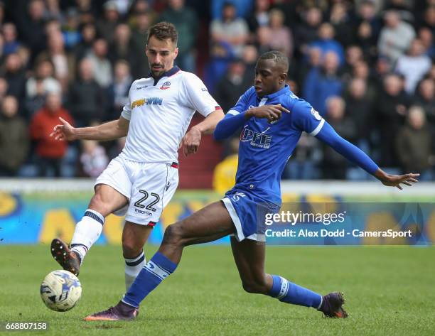 Bolton Wanderers' Filipe Morais plays a ball down the line despite the attentions of Oldham Athletic's Ousmane Fane during the Sky Bet League One...