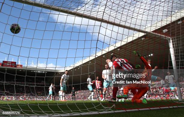 Victor Anichebe of Sunderland challenges Darren Randolph of West Ham United as Wahbi Khazri of Sunderland scores his sides first goal during the...