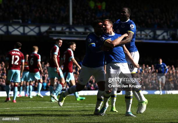 Phil Jagielka of Everton celebrates scoring his sides first goal with his Everton team mates during the Premier League match between Everton and...