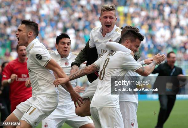 Suso of AC Milan with his team-mate Juraj Kucka and Lucas Ocampos celebrates at the end of the Serie A match between FC Internazionale and AC Milan...