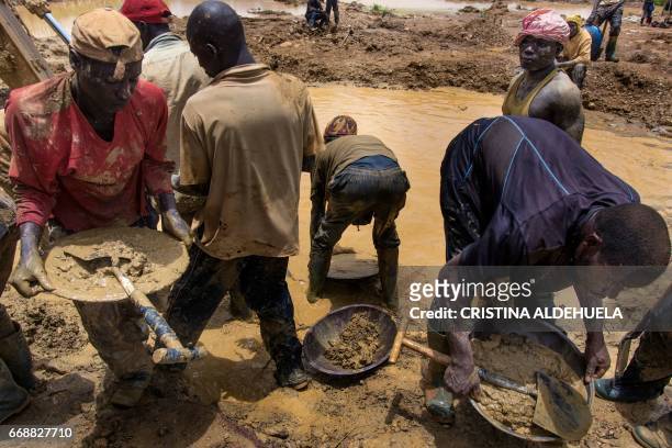 Galamseyers, illegal miners from Niger, work beside a pond close to Kibi town on April 10, 2017. Immigrants from Niger, Togo or Burkina Faso have...
