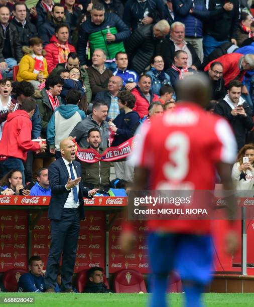 Real Madrid's French coach Zinedine Zidane shouts after the second goal scored by Sporting Gijon's midfielder Mikel Vesga during the Spanish league...