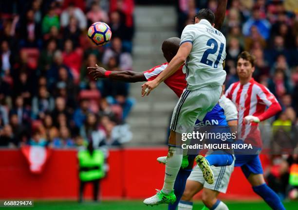 Real Madrid's forward Alvaro Morata heads the ball to score a goal during the Spanish league football match Real Sporting de Gijon vs Real Madrid CF...