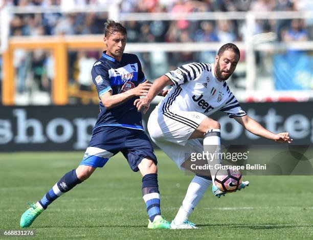 Andrea Coda of Pescara Calcio and Gonzalo Higuain of Juventus FC in action during the Serie A match between Pescara Calcio and Juventus FC at...