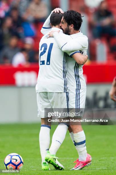 Alvaro Morata of Real Madrid celebrates with his teammates Isco of Real Madrid after scoring his team's second goal during the La Liga match between...