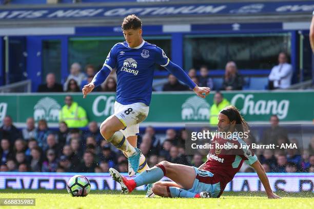 Ross Barkley of Everton and George Boyd of Burnley during the Premier League match between Everton and Burnley at Goodison Park on April 15, 2017 in...