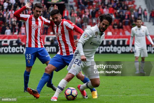 Carlos Carmona midfielder of Sporting de Gijon battles for the ball with Francisco Roman &quot;Isco&quot; midfielder of Real Madrid during the La...