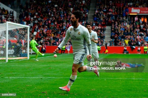 Real Madrid's midfielder Isco celebrates after scoring a goal during the Spanish league football match Real Sporting de Gijon vs Real Madrid CF at El...