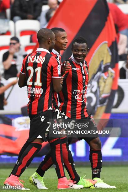 Nice's Ivorian midfielder Jean Michel Seri celebrates with his teammates after scoring a goal during the French L1 Football match between OGC Nice...