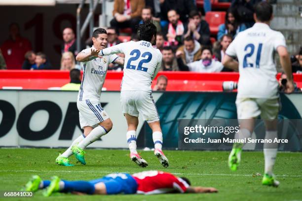 Isco of Real Madrid celebrates after scoring his team's third goal during the La Liga match between Real Sporting de Gijon and Real Madrid at Estadio...