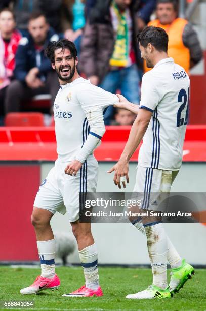 Isco of Real Madrid celebrates with his teammates Alvaro Morata of Real Madrid after scoring his team's third goal during the La Liga match between...