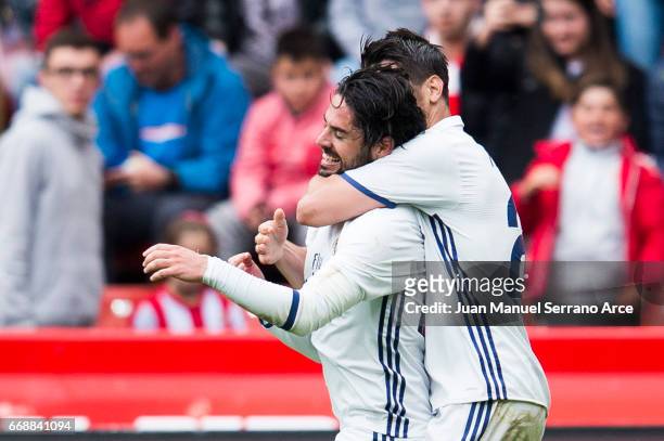 Isco of Real Madrid celebrates with his teammates Alvaro Morata of Real Madrid after scoring his team's third goal during the La Liga match between...
