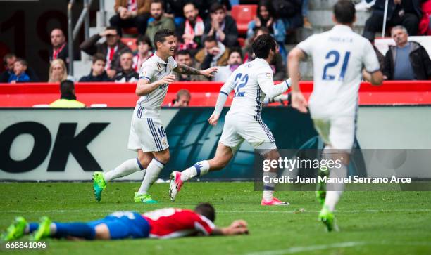 Isco of Real Madrid celebrates after scoring his team's third goal during the La Liga match between Real Sporting de Gijon and Real Madrid at Estadio...