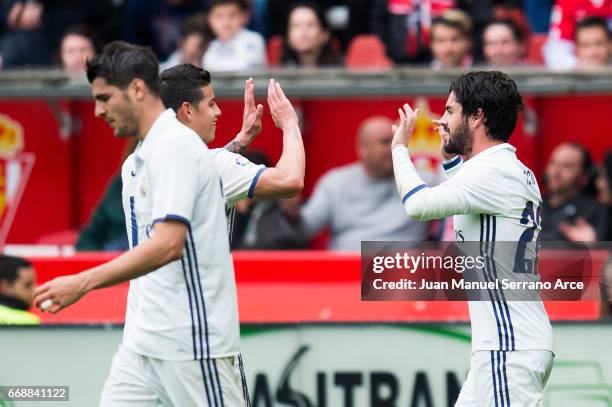 Isco of Real Madrid celebrates with his teammates James Rodriguez of Real Madrid after scoring his team's third goal during the La Liga match between...