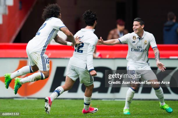 Isco of Real Madrid celebrates after scoring his team's third goal during the La Liga match between Real Sporting de Gijon and Real Madrid at Estadio...