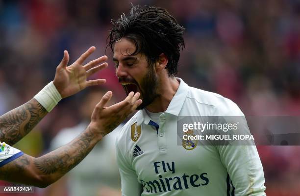 Real Madrid's midfielder Isco celebrates after scoring a goal during the Spanish league football match Real Sporting de Gijon vs Real Madrid CF at El...