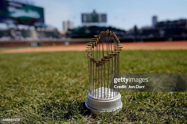 Replica World Series Trophy, today's promotional giveaway, on the field before the game between the Chicago Cubs and the Pittsburgh Pirates at...
