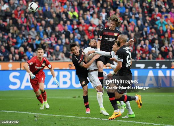 Arturo Vidal of FC Bayern Muenchen misses to score against Charles Aranguiz of Leverkusen and Tin Jedvaj of Leverkusen during the Bundesliga match...