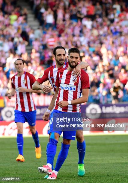 Atletico Madrid's Belgian midfielder Yannick Ferreira Carrasco celebrates with Atletico Madrid's defender Juanfran after scoring during the Spanish...
