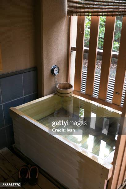 japanese style wooden bath with steam, ofuro bath - bathroom pot plant stock pictures, royalty-free photos & images