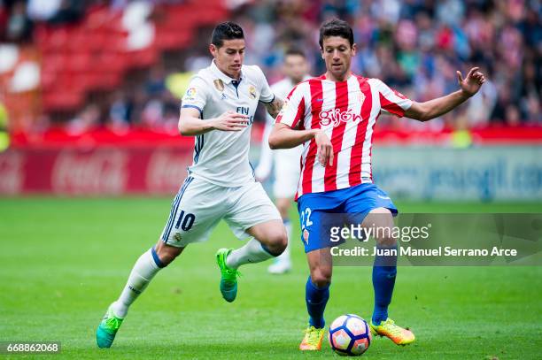 James Rodriguez of Real Madrid duels for the ball with Mikel Vesga of Real Sporting de Gijon during the La Liga match between Real Sporting de Gijon...