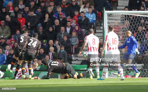 Hull City's Harry Maguire scores his sides first goal beating Stoke City's Lee Grant during the Premier League match between Stoke City and Hull City...