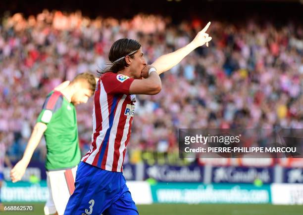 Atletico Madrid's Brazilian defender Filipe Luis celebrates after scoring during the Spanish league football match Atletico de Madrid vs Osasuna at...