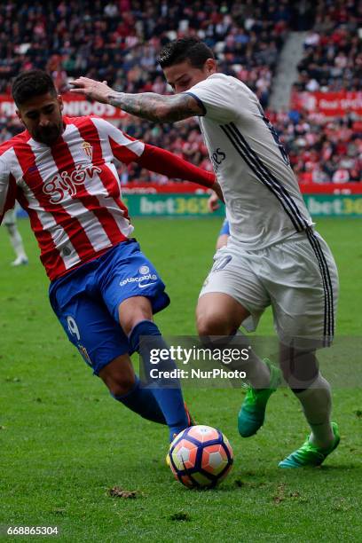 James Rodriguez midfielder of Real Madrid battles for the ball with Carlos Carmona midfielder of Sporting de Gijon during the La Liga Santander match...