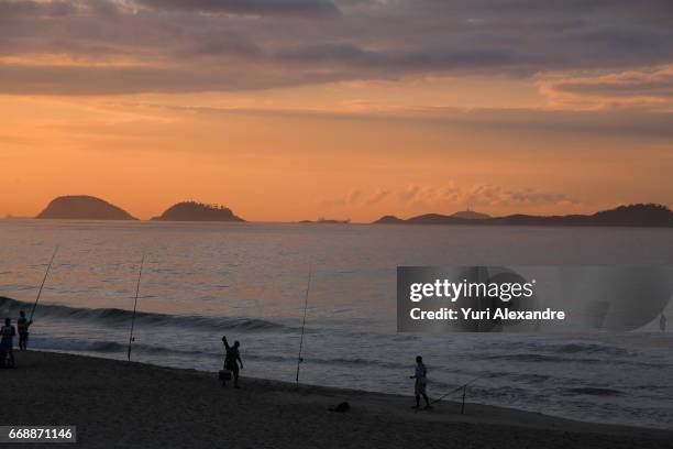 fisherman in sao conrado beach, rio de janeiro - sao conrado beach stock pictures, royalty-free photos & images