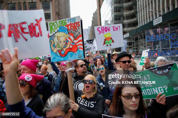 Protestors take part in the "Tax March" to call on US President Donald Trump to release his tax records on April 15, 2017 in New York.