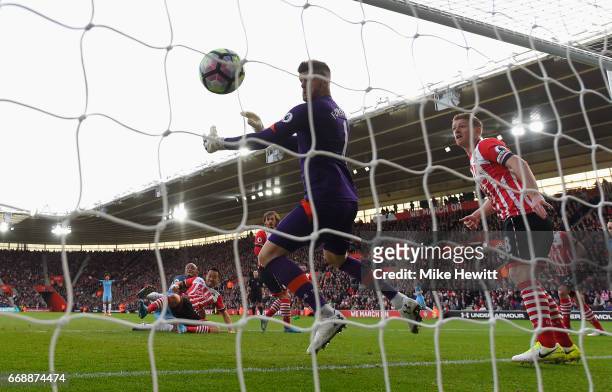 Vincent Kompany of Manchester City scores his sides first goal past Fraser Forster of Southampton during the Premier League match between Southampton...